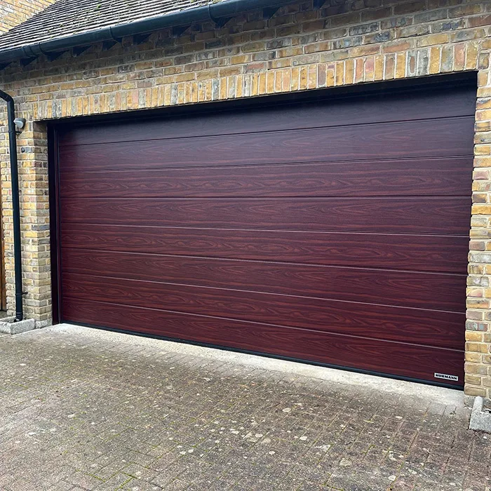 HormannUK LPU42 M-Ribbed Sectional door, finished in Rosewood Decograin Laminate Surface