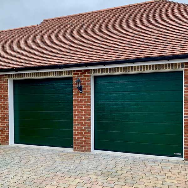 Double Hormann LPU 42 M-ribbed Green Sectional Garage Doors recently installed in Berkshire